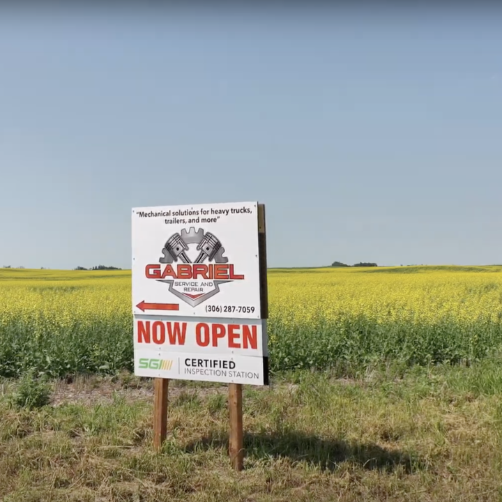 Now Open Sign in Canola Field